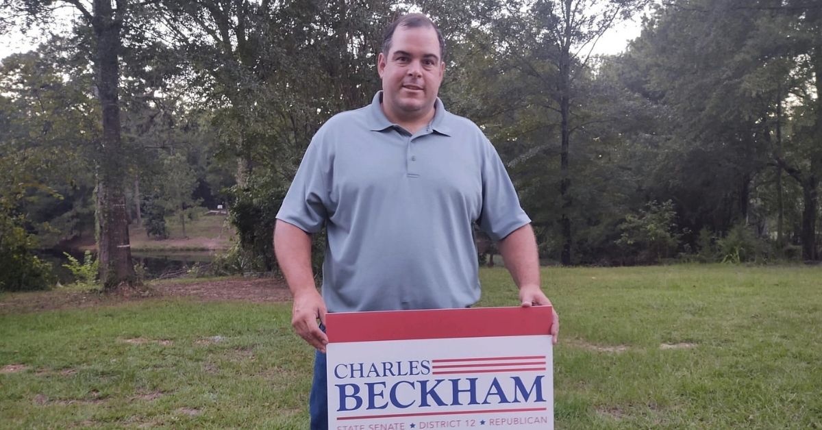 Beckham holding his campaign yard sign